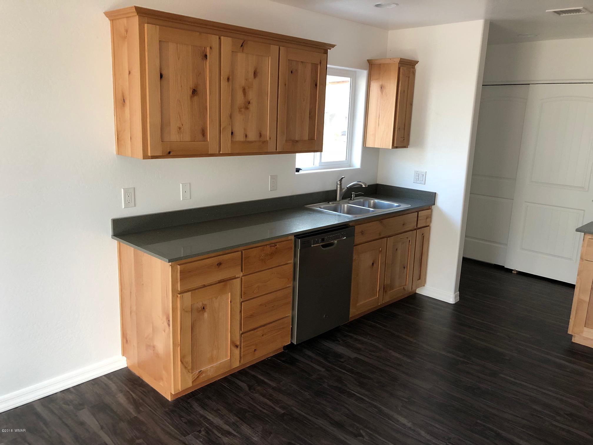 345 South 5th W Street Snowflake, AZ 85937 - Photo 5 of 11 a kitchen with stainless steel appliances granite countertop a sink a stove a microwave cabinets and wooden floor