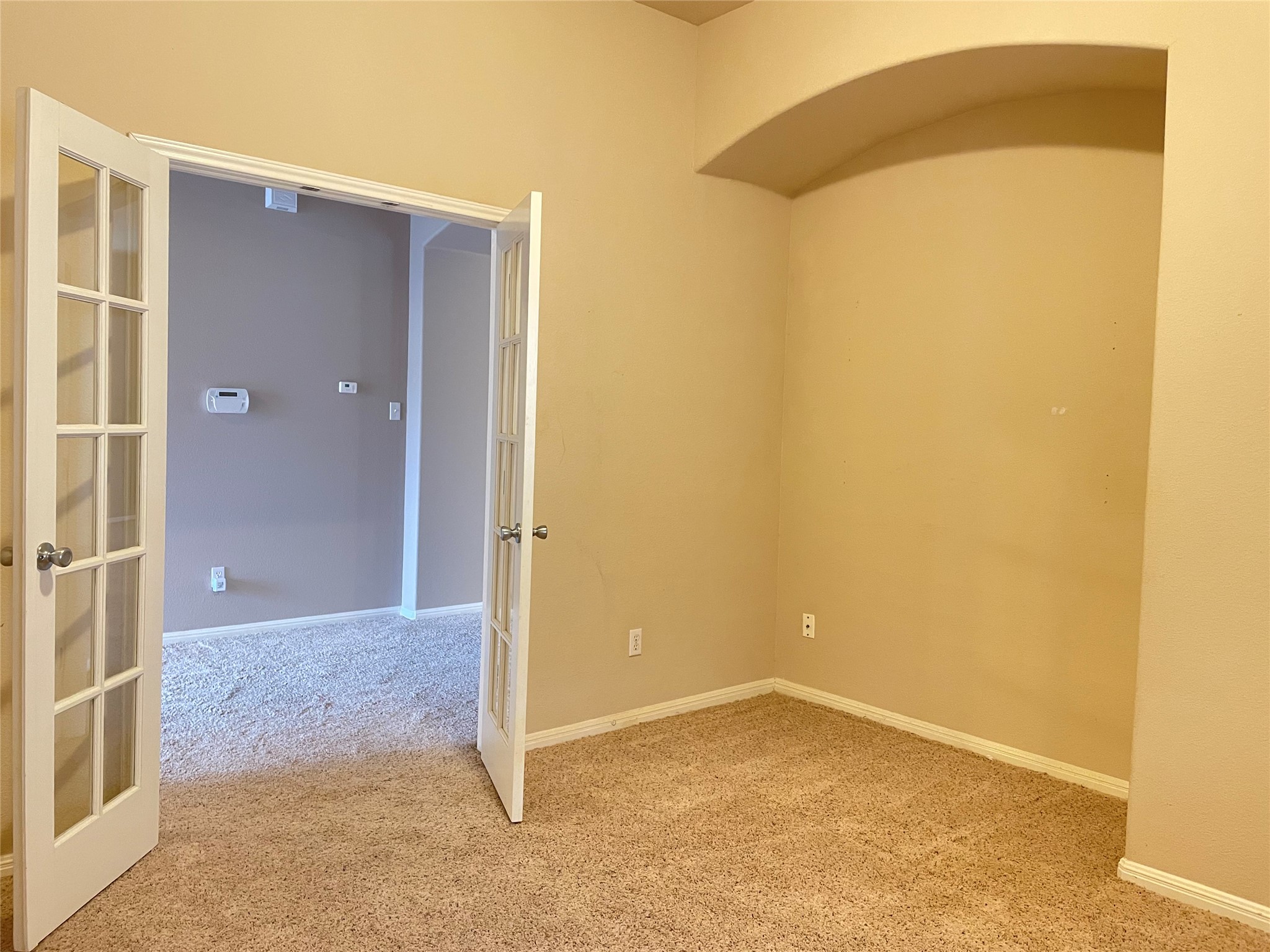 11713 Dunblane Way Austin, TX 78754 - Photo 4 of 22 French doors opening to a secondary room featuring neutral-toned walls and plush carpeting