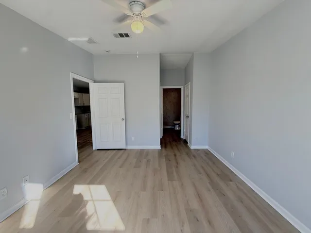 wooden floor in an empty room with a window