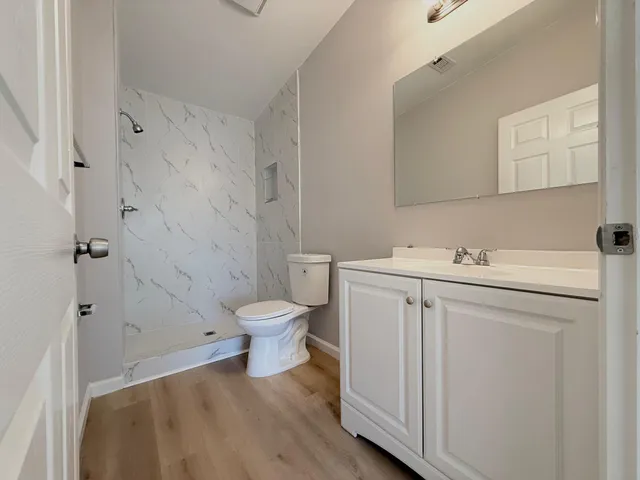 a view of a bathroom with a sink toilet and a mirror