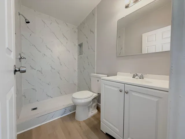 a bathroom with a toilet and a shower