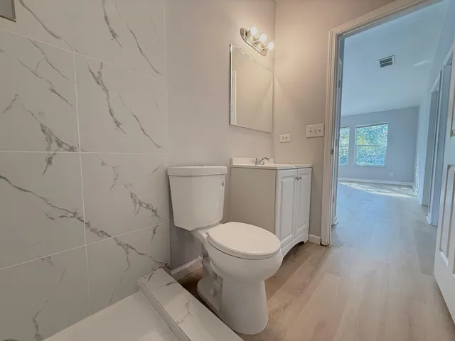 a bathroom with a toilet and a shower