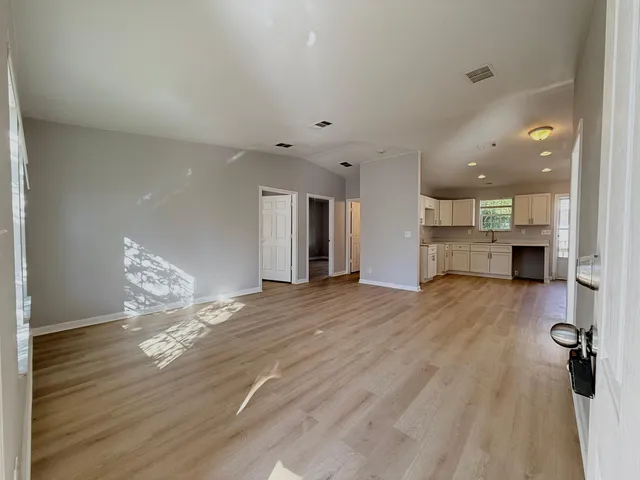 a view of kitchen and hall with wooden floor