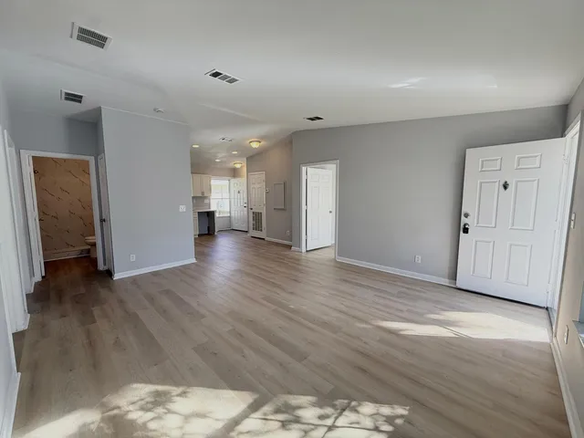 a view of a hallway with wooden floor