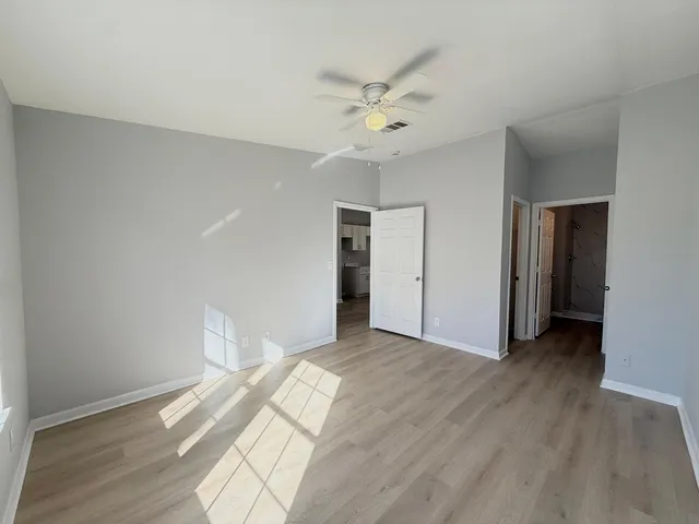 a view of an empty room with wooden floor