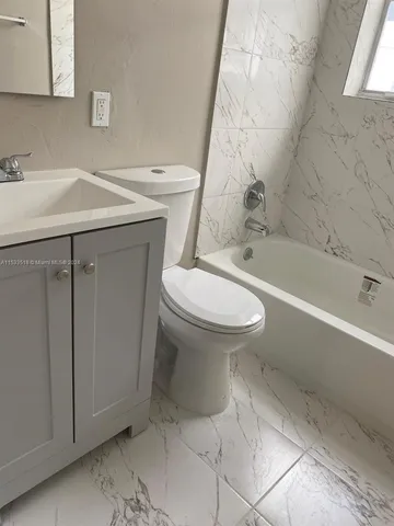 a bathroom with a sink toilet and bathtub