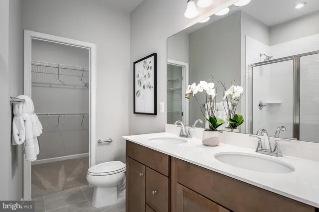 a bathroom with a toilet a sink and a large mirror