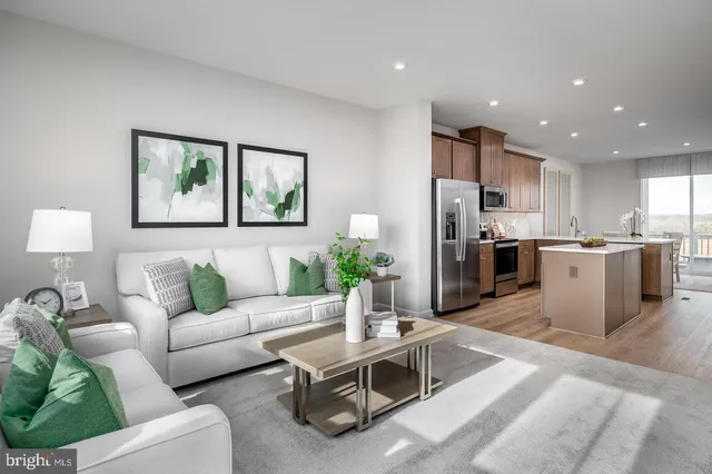 a living room with furniture kitchen and a table
