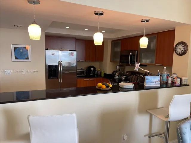 a kitchen with counter top space and a chandelier
