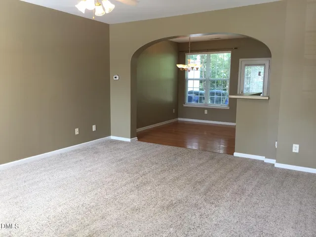 an empty room with windows and entrance