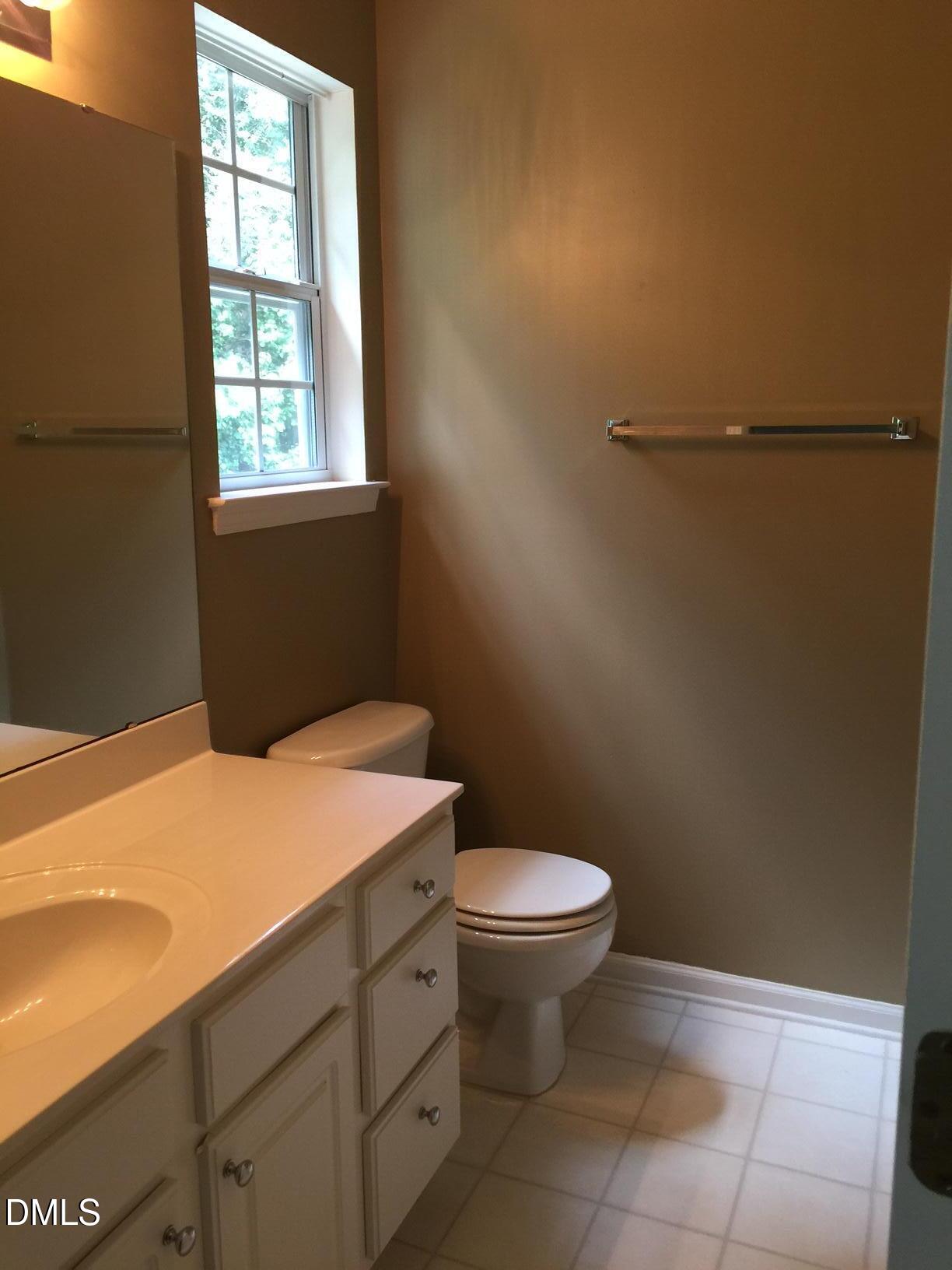 2006 Lost Lane Raleigh, NC 27603 - Photo 7 of 9 a bathroom with a sink a toilet and window