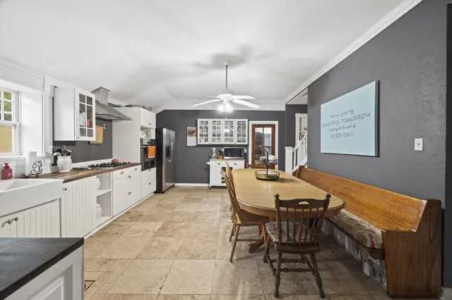 a large kitchen with a table and chairs