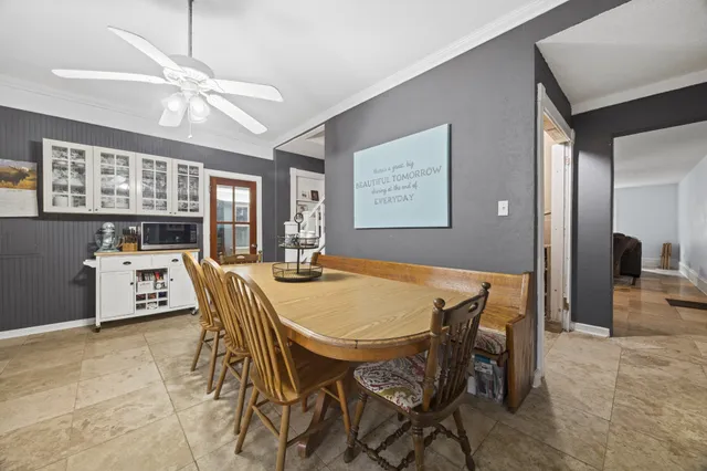 a view of a dining room with furniture and a chandelier