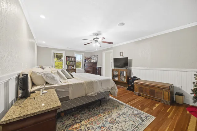 a spacious bedroom with a bed and glass door