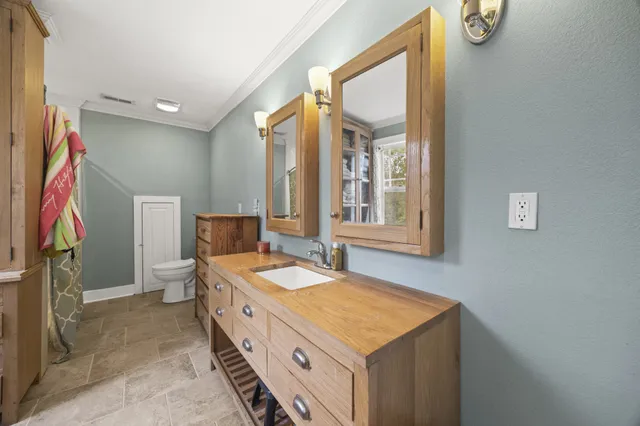 a spacious bathroom with a granite countertop sink and a mirror