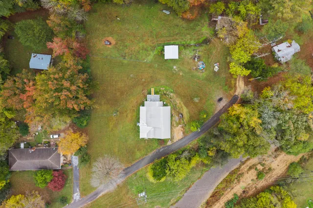 an aerial view of a residential houses with outdoor space