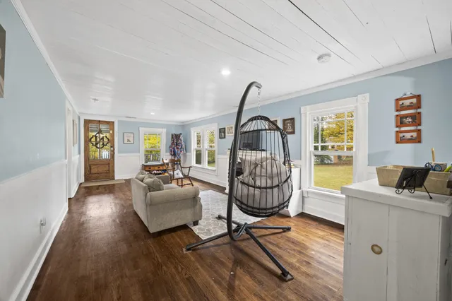 a living room with furniture a window and gym equipment
