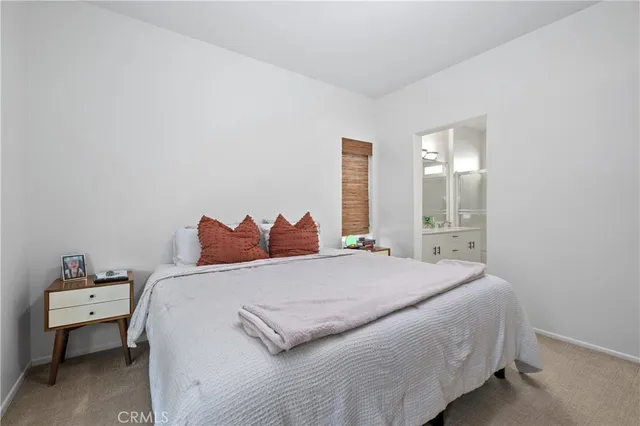 a bedroom with a bed and a lamp