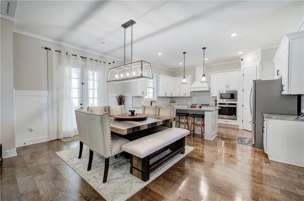 a kitchen with stainless steel appliances white cabinets and a window