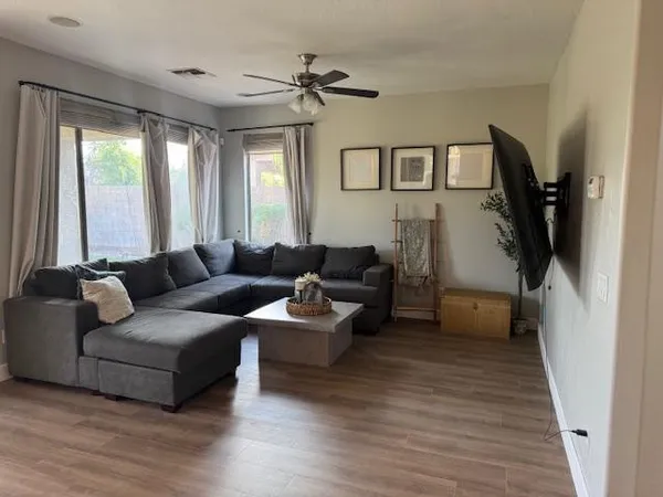 a living room with furniture and large windows