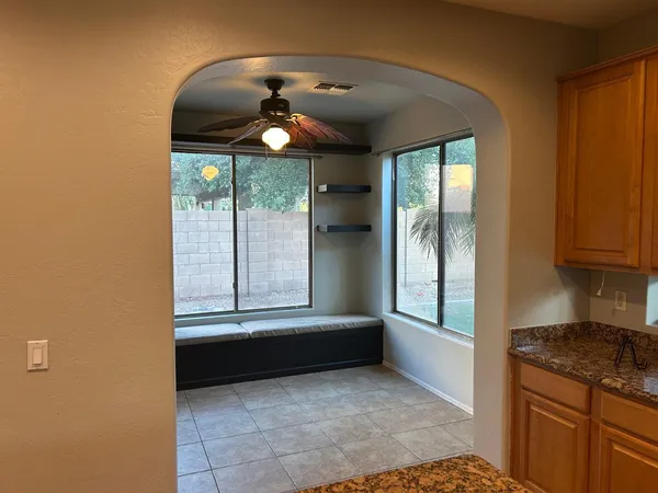 a kitchen with stainless steel appliances granite countertop a sink and a refrigerator
