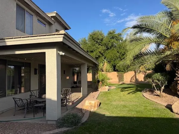 a view of a house with pool and sitting area