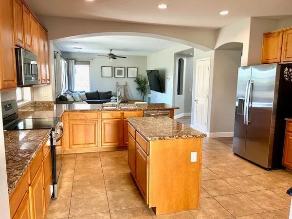 a kitchen with granite countertop a sink stove top oven and cabinets
