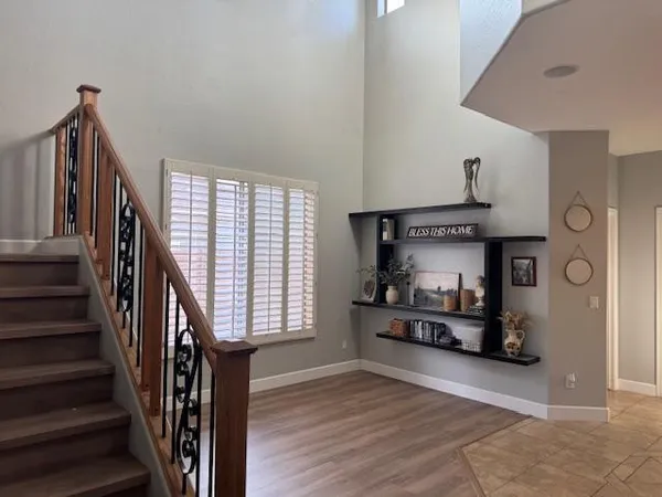 a view of staircase with railing and a window