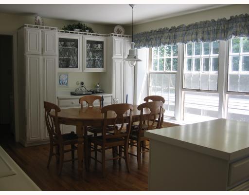140 Witherow Road Bell Acres, PA 15143 - Photo 6 of 8 Kitchen. White cabinets, a moveable island and newer appliances fill the twenty-foot eat-in kitchen. The deck can be glimpsed through the triple windows; it has abundant seating built around much of the perimeter.