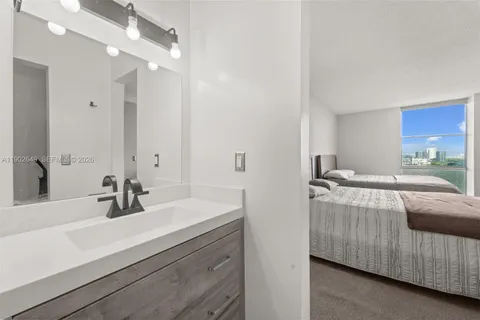 a bathroom with a sink double vanity and a mirror