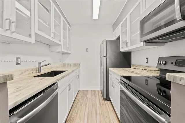 a kitchen with a sink stove and cabinets