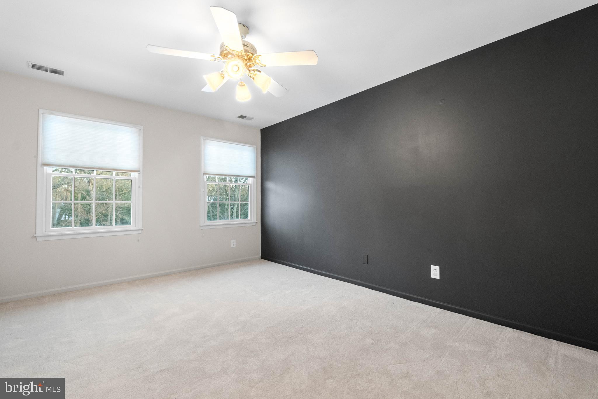 1 Braddocks Mill Road Medford, NJ 08055 - Photo 37 of 61 an empty room with windows and chandelier fan