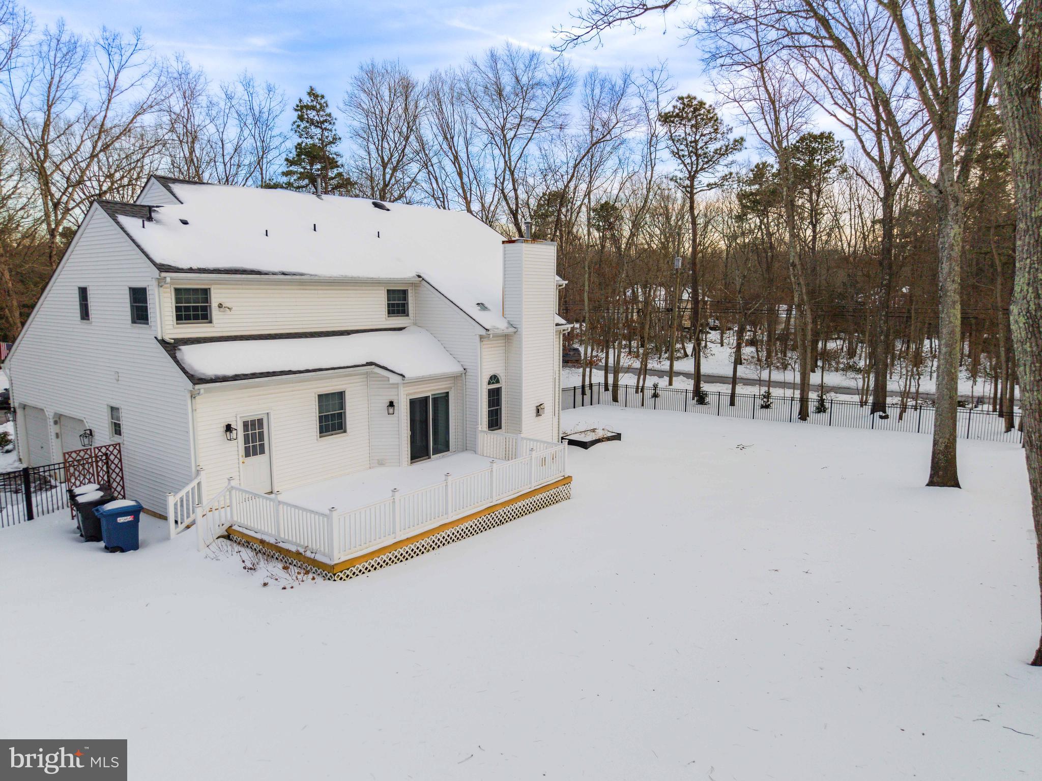 1 Braddocks Mill Road Medford, NJ 08055 - Photo 49 of 61 a view of a white house with a yard covered in snow