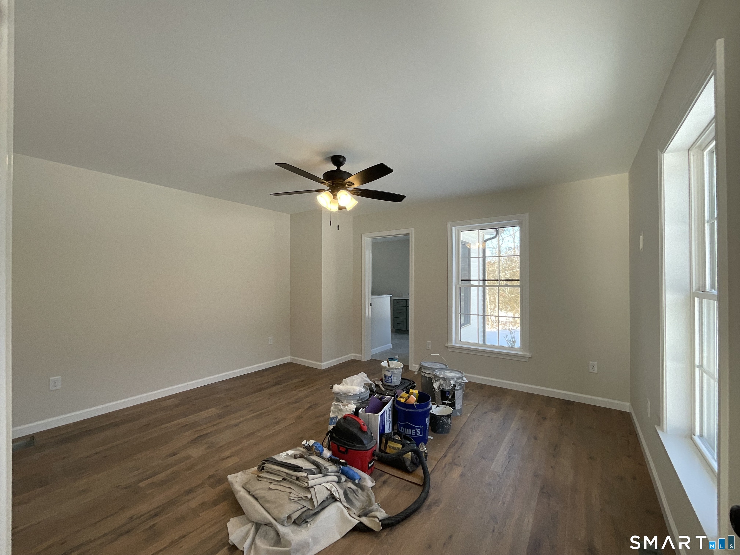 277 Moosup Pond Road Plainfield, CT 06354 - Photo 11 of 25 a view of a livingroom with wooden floor and a ceiling fan