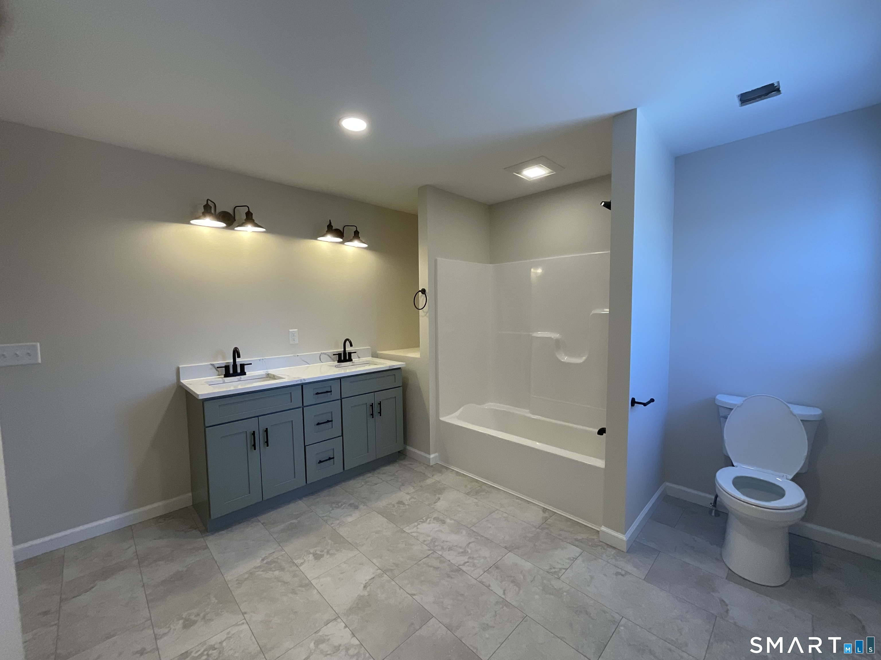 277 Moosup Pond Road Plainfield, CT 06354 - Photo 17 of 25 a spacious bathroom with a double vanity sink toilet and a shower