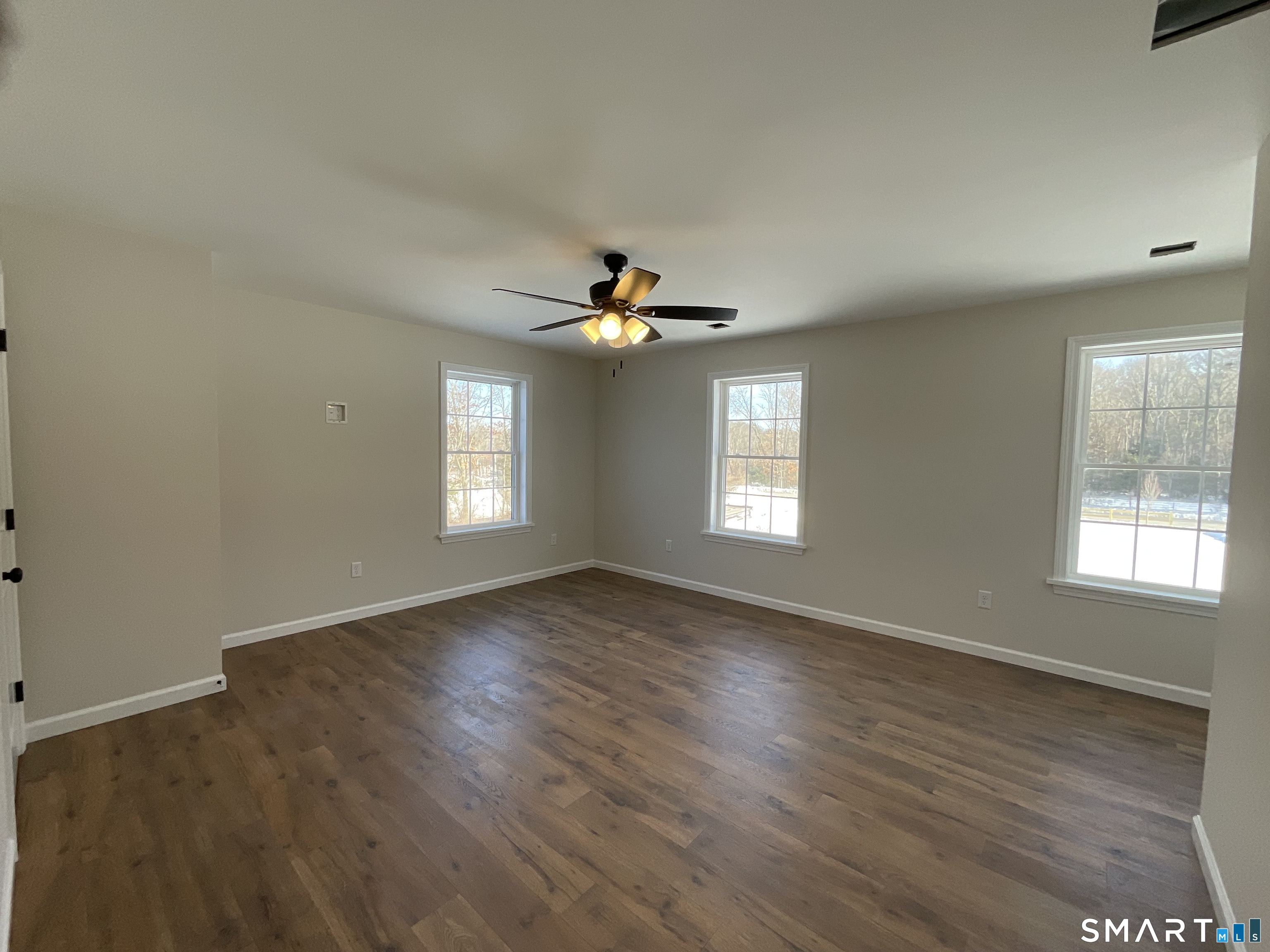 277 Moosup Pond Road Plainfield, CT 06354 - Photo 18 of 25 an empty room with wooden floor and windows
