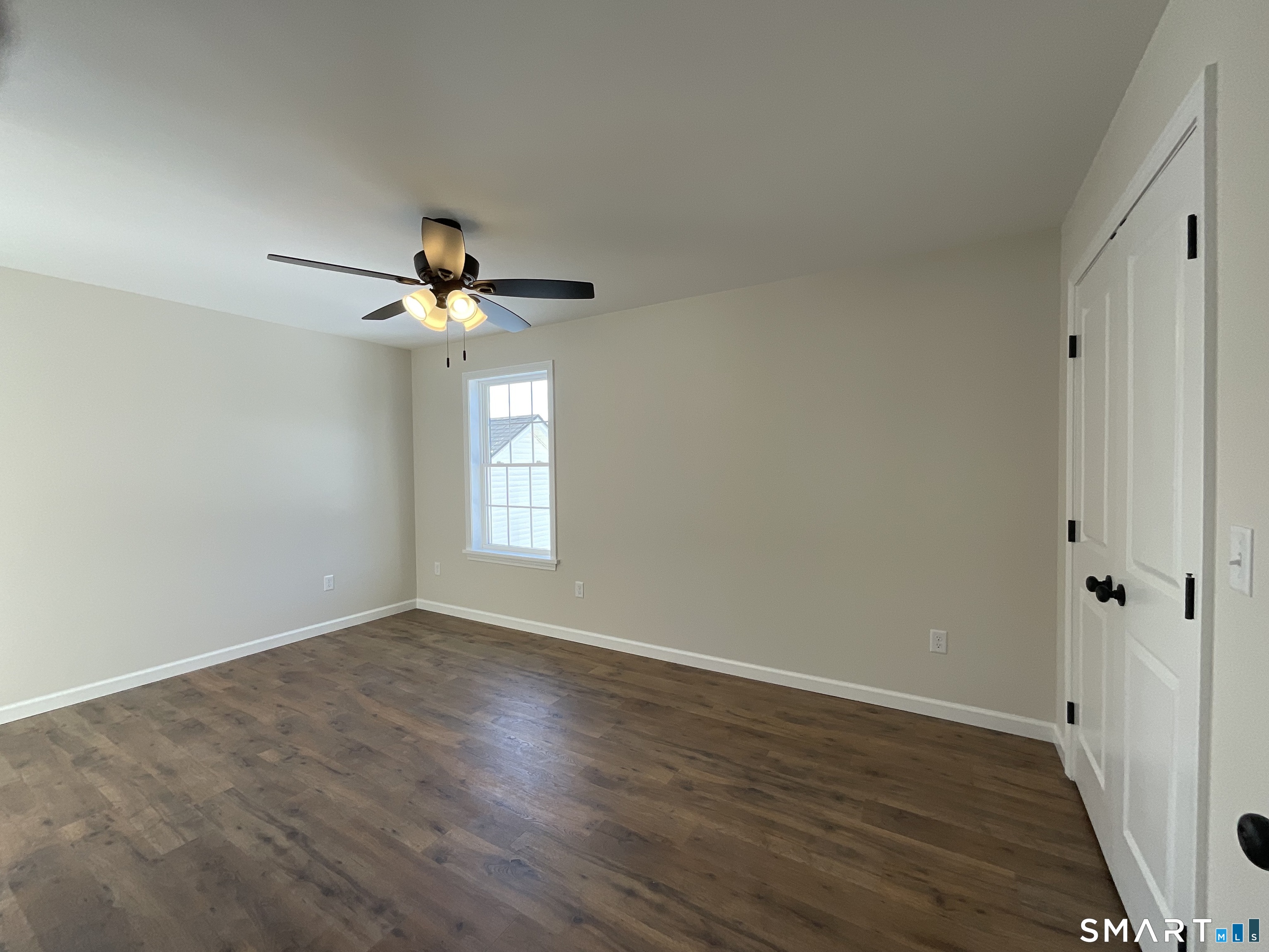 277 Moosup Pond Road Plainfield, CT 06354 - Photo 21 of 25 a view of wooden floor and a chandelier fan in an empty room