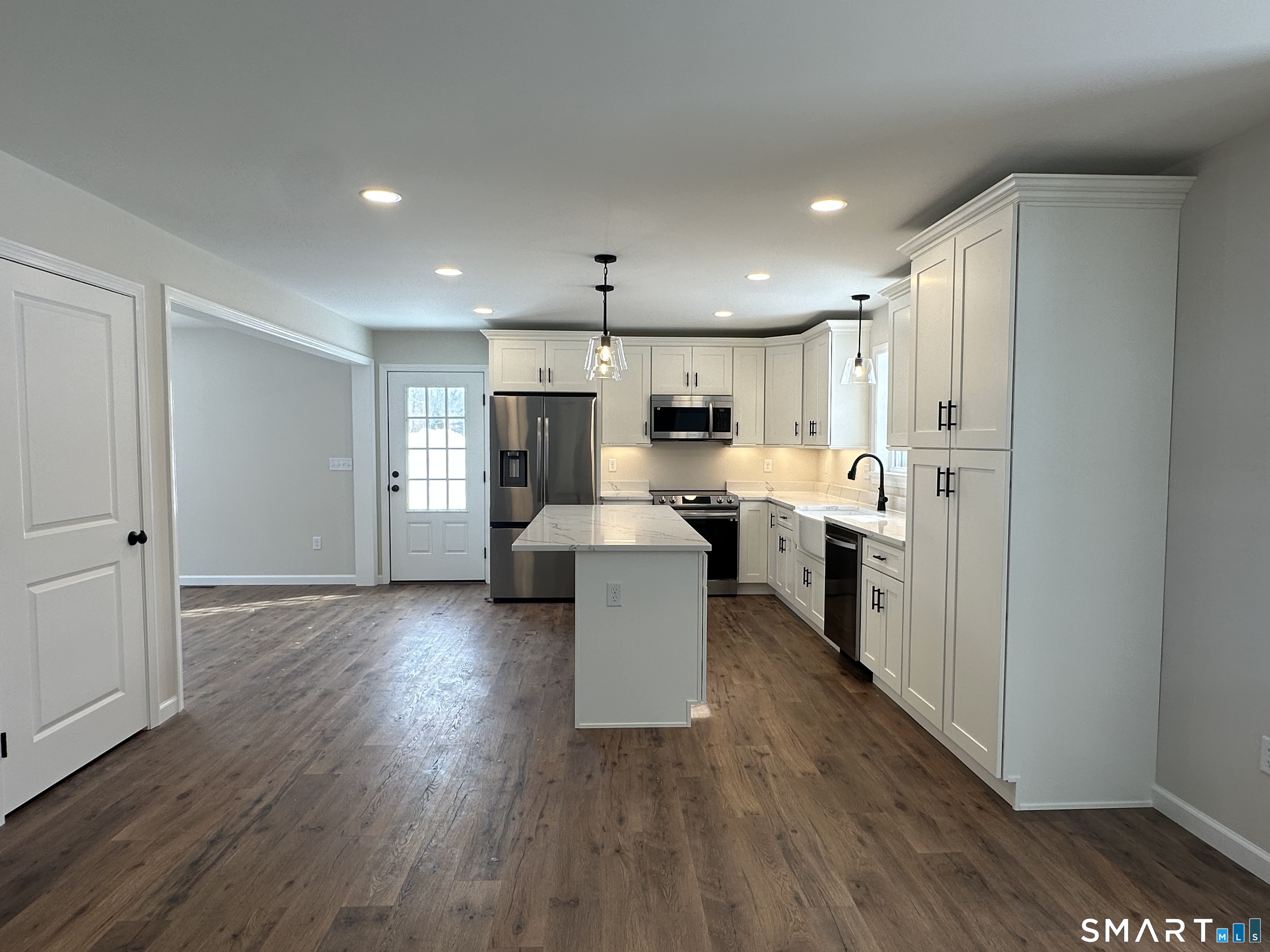 277 Moosup Pond Road Plainfield, CT 06354 - Photo 25 of 25 a kitchen with a refrigerator and a stove top oven