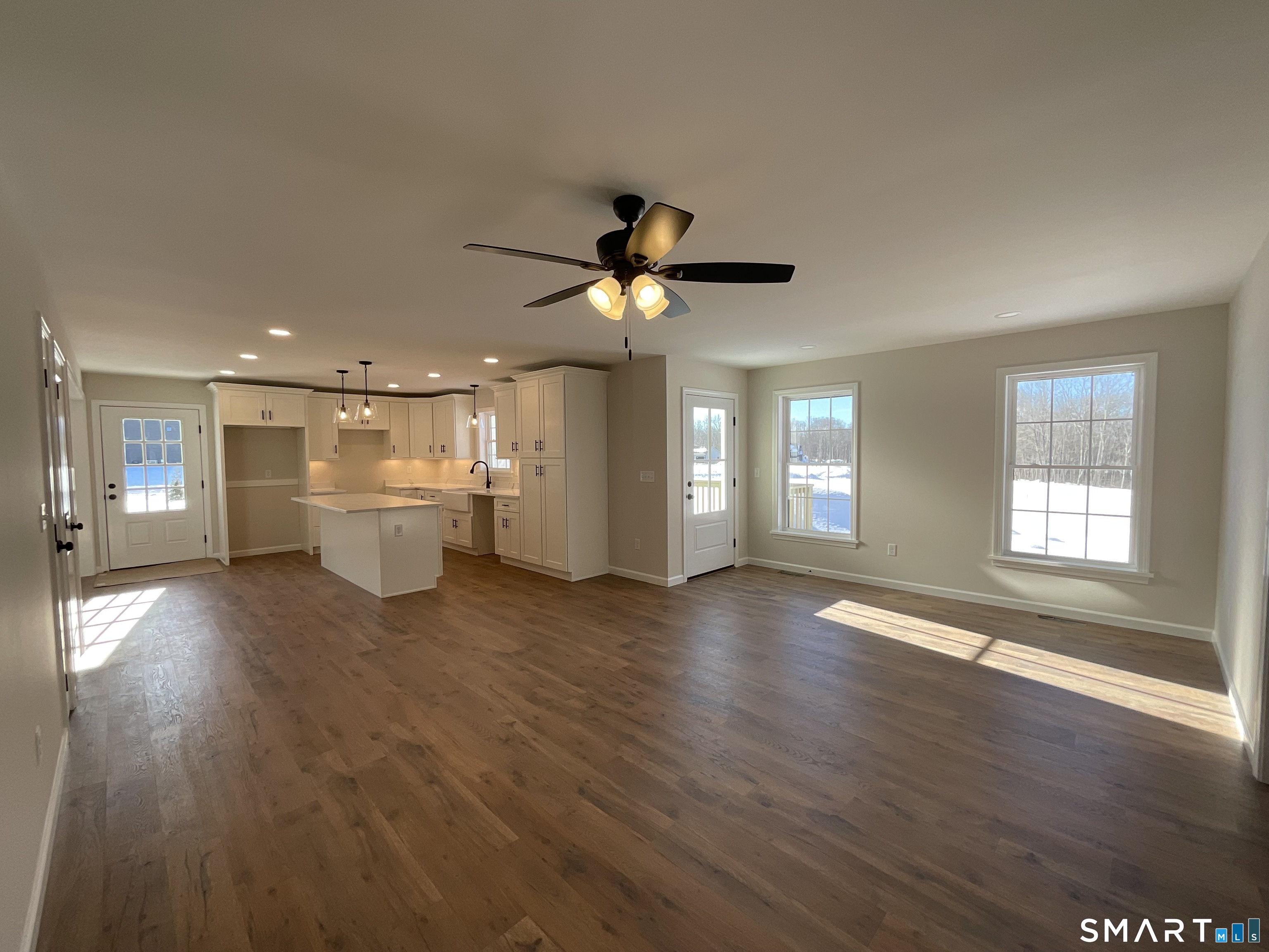 277 Moosup Pond Road Plainfield, CT 06354 - Photo 4 of 25 a view of an empty room with a kitchen and wooden floor
