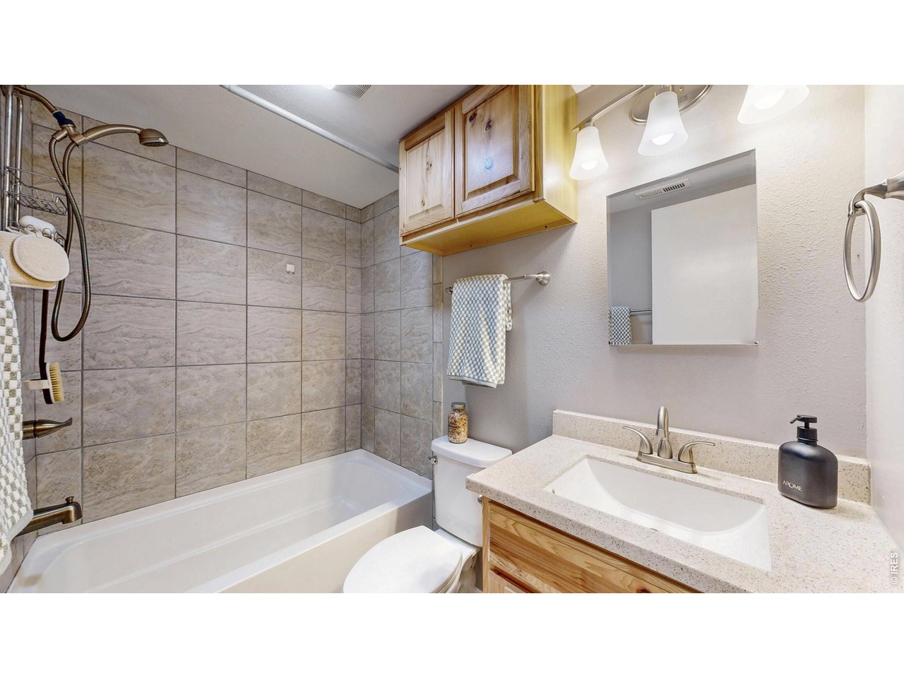 200 Riverside Drive, Unit 1 Estes Park, CO 80517 - Photo 14 of 27 a bathroom with a sink a bathtub and a shower