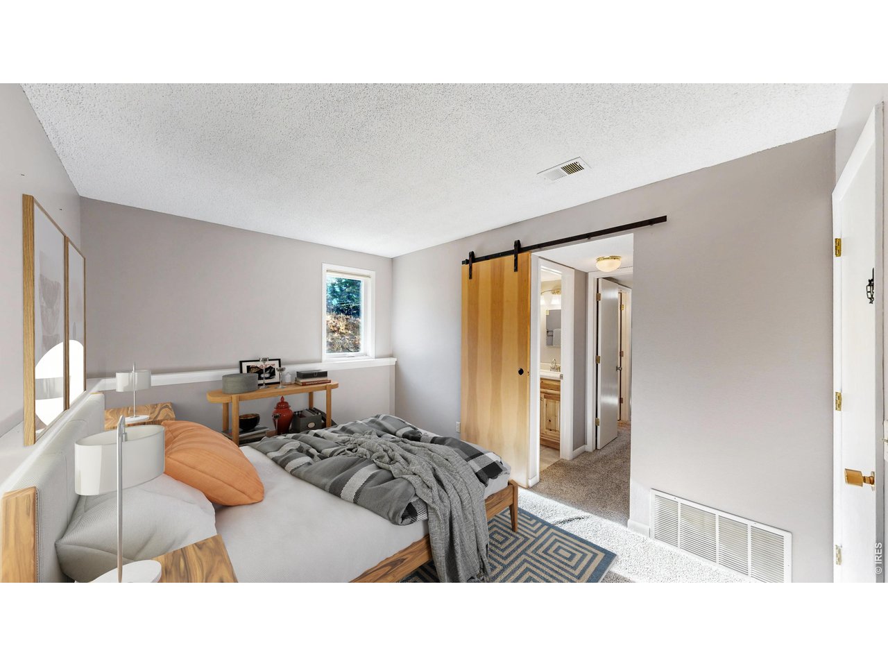 200 Riverside Drive, Unit 1 Estes Park, CO 80517 - Photo 3 of 27 a bedroom with a bed and wooden floor