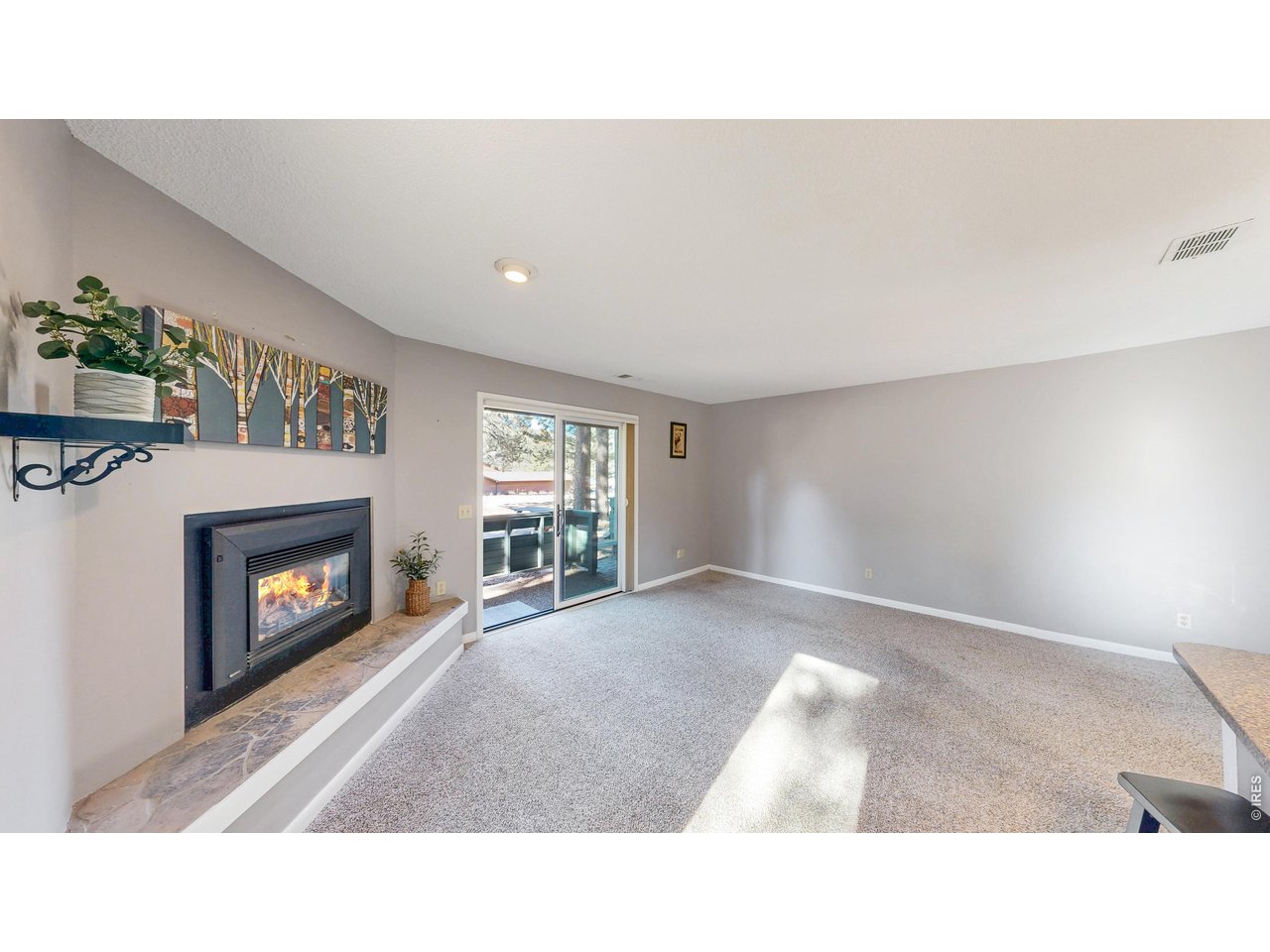 200 Riverside Drive, Unit 1 Estes Park, CO 80517 - Photo 8 of 27 a living room with a fireplace furniture and a fireplace
