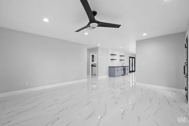 a view of a kitchen with a sink and a refrigerator