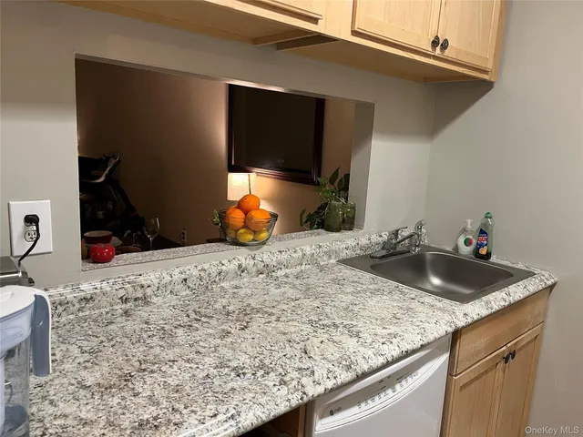 a kitchen with sink and granite counter top