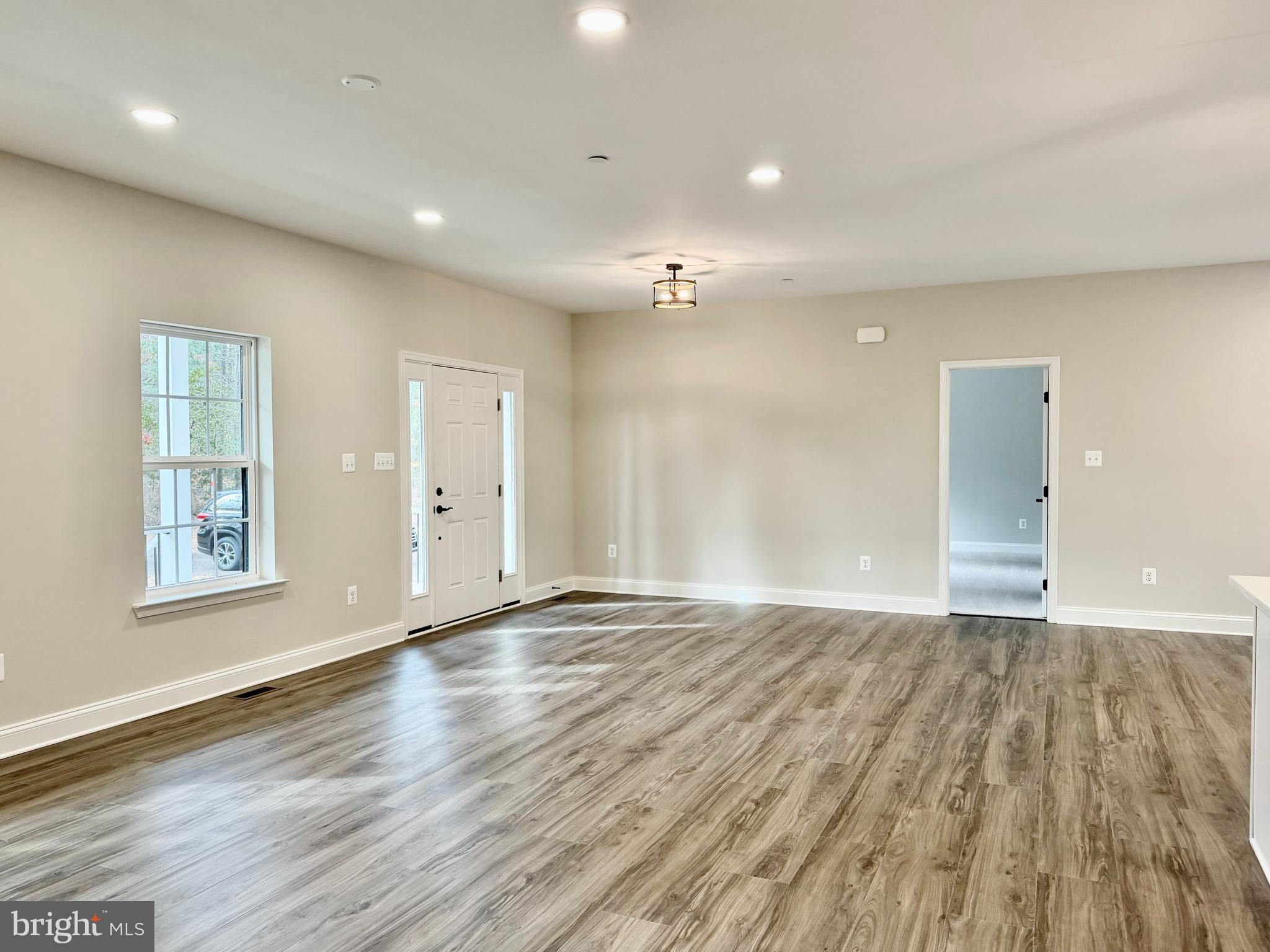 44968 Hewitt Road Callaway, MD 20620 - Photo 2 of 33 a view of an empty room with wooden floor and a window