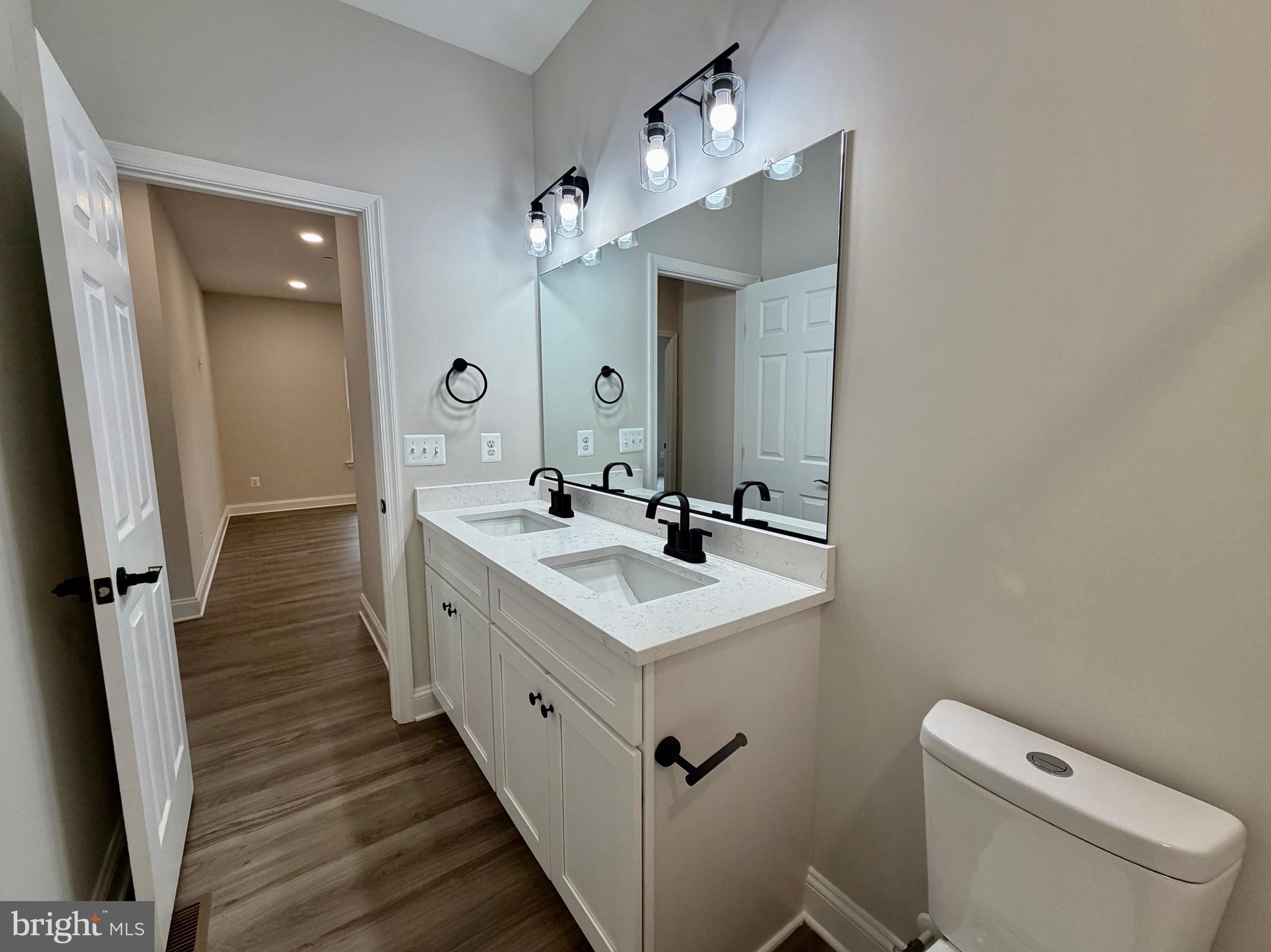 44968 Hewitt Road Callaway, MD 20620 - Photo 22 of 33 a bathroom with a sink a toilet a mirror and shower