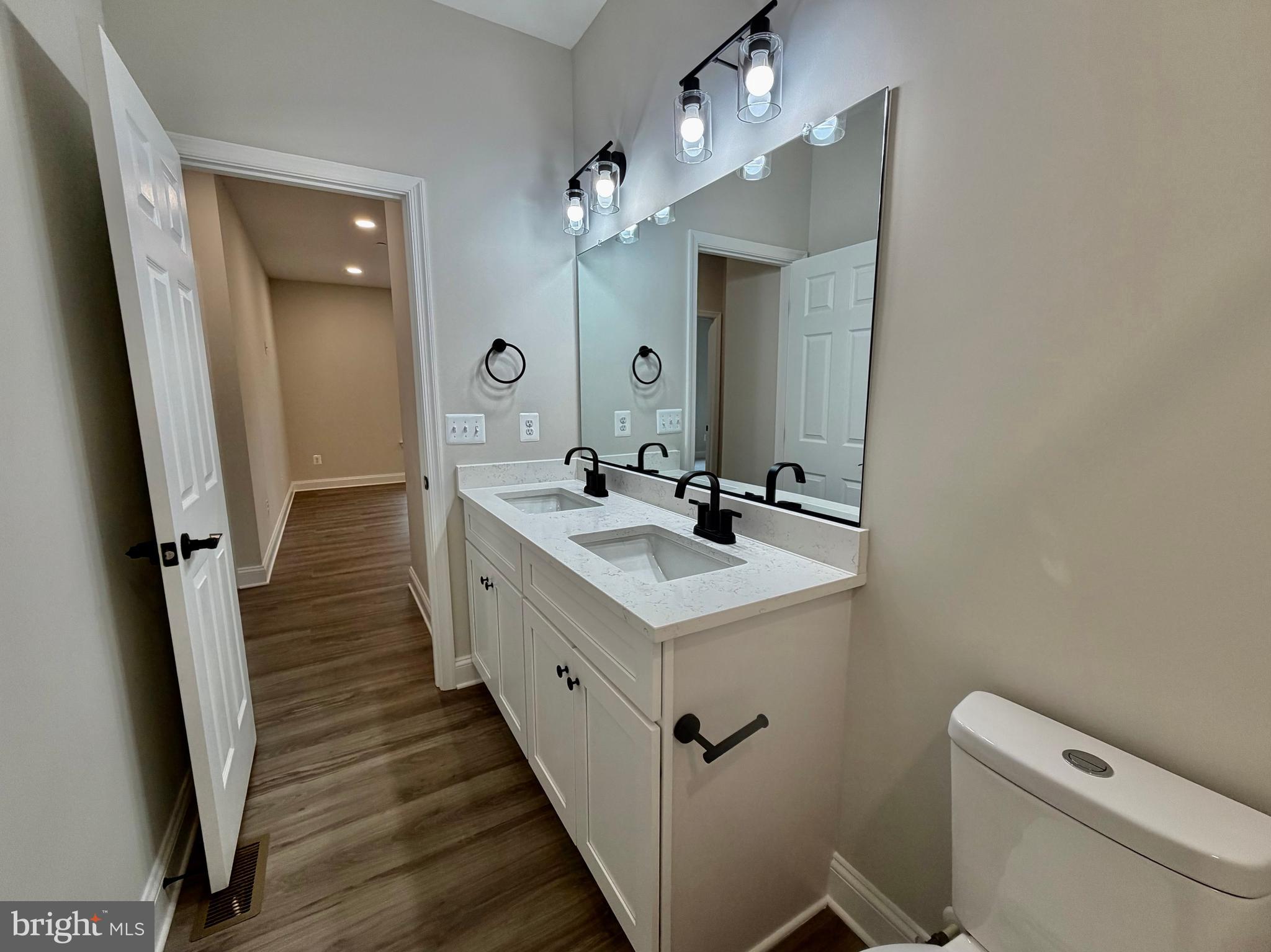 44968 Hewitt Road Callaway, MD 20620 - Photo 23 of 33 a bathroom with a sink a toilet a mirror and shower