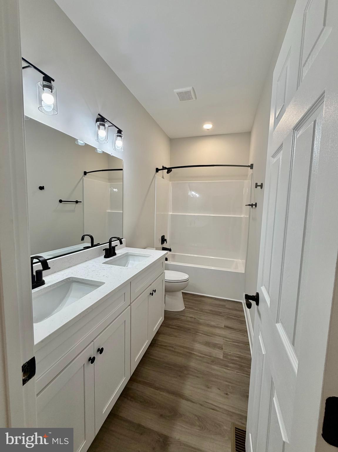 44968 Hewitt Road Callaway, MD 20620 - Photo 24 of 33 a bathroom with a double vanity sink a mirror and a shower