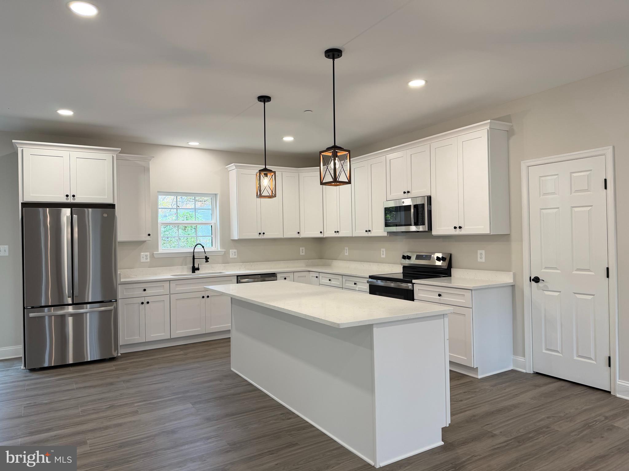 44968 Hewitt Road Callaway, MD 20620 - Photo 5 of 33 a kitchen with stainless steel appliances granite countertop a refrigerator a sink dishwasher a stove and white cabinets with wooden floor