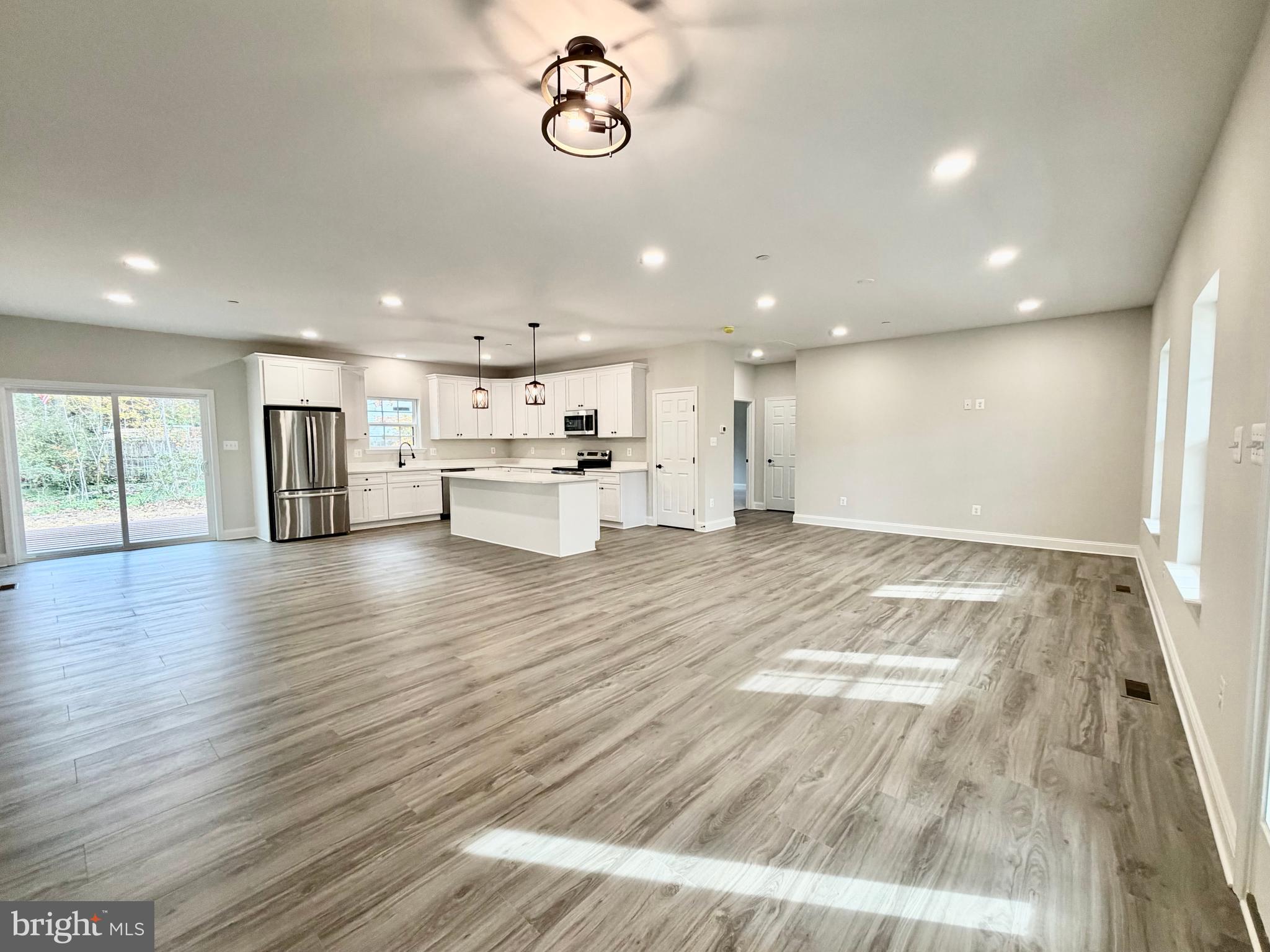 44968 Hewitt Road Callaway, MD 20620 - Photo 8 of 33 a view of kitchen with kitchen island white cabinets and wooden floor